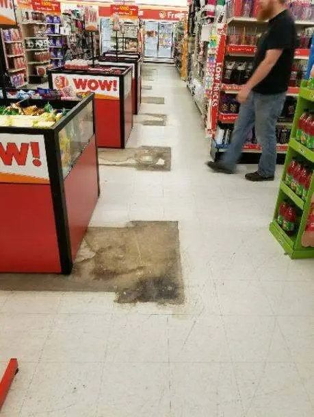 Retail store floor before professional cleaning, showing worn and stained tile